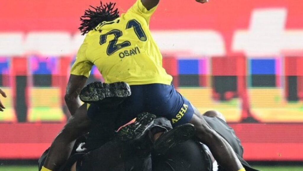 Nigerian Footballer Osayi-Samuel Protects Teammates from Pitch Invaders