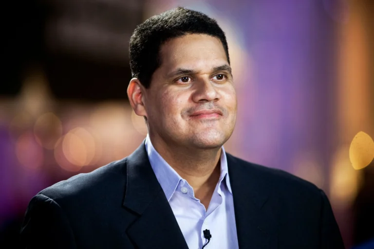 Reggie Fils-Aimé Didn't Try to Beat Nintendo's Rivals. He Changed the Game Nobody thought Nintendo needed reinventing. Not really. When Reggie Fils-Aimé joined Nintendo of America in 2004, the company was falling behind fast. Sony's PlayStation 2 and Microsoft's Xbox owned the console market. The GameCube had moved about 21.7 million units worldwide. The PS2? Over 155 million. Not even close. Everyone assumed the answer was obvious: build something more powerful, go head-to-head on specs. Fils-Aimé didn't buy it. He thought Nintendo's real opportunity was people who never called themselves gamers in the first place. Forget chasing rivals on horsepower. Grow the audience instead. It was a real gamble. If it flopped, Nintendo could've slid even further behind. It didn't flop. It set up the Wii's massive breakout. The Bet: Give Away the Thing That Explains the Thing Before the Wii launched in 2006, Fils-Aimé pushed hard for one idea: pack Wii Sports in the box, free. Iwata said no at first. Nintendo had always treated its games as premium products, moneymakers in their own right. Giving one away meant walking away from serious revenue. But Fils-Aimé wasn't thinking about generosity. He was thinking about acquisition. His own words later: "The goal of Wii is to expand gaming from its current niche to a mass-market medium." Nintendo eventually caved and bundled it in the Americas. The results speak for themselves. Wii sold 101.63 million units worldwide, dwarfing the GameCube's 21.74 million. Wii Sports, riding that bundle, reached at least 82.79 million copies. The real lesson here isn't just "give stuff away." It's sharper than that. Sometimes a product's biggest value isn't in selling it. It's in using it to kill the customer's doubt about something else. Three Rules Behind Reggie's Decisions Expand the category instead of fighting over it. While everyone else polished the existing game, Reggie asked who else could be playing. "You have to pursue new innovative ideas that break the mold." The Wii went after families, older adults, casual players — not the graphics-chasing core crowd. Still unmistakably Nintendo, just reaching further. Make the innovation explain itself. A great product still dies if nobody can explain why it matters in one sentence. Nintendo's goal: make it "crystal clear what the proposition is." That's exactly why the Switch got pitched so simply — a home console you can take anywhere. Clean. No confusion, unlike what happened with the Wii U. Treat failure as research. Find the exact assumption that broke. Then rebuild around it. The Wii U had two problems: nobody understood what it was for, and there wasn't enough great software to keep people playing. Nintendo tackled both head-on with Switch. The $100 Million Idea That Became a 13.56 Million-Unit Warning The Wii U was the cautionary tale nobody talks about enough. After the Wii's 101.63 million in sales, Wii U limped to just 13.56 million. Fils-Aimé later admitted where it went wrong — positioning was muddy, and the software pipeline dried up. But Nintendo didn't scrap the idea. It fixed it. Switch kept the off-TV flexibility Wii U tried to offer, but made the portability the whole point, impossible to miss. By June 30, 2026, Switch had sold 156.59 million units worldwide. Fils-Aimé helped get it off the ground, though most of that success came after his 2019 retirement. The Network Behind the Contrarian Iwata and Miyamoto brought the institutional weight and creative firepower — though both pushed back on the Wii Sports idea at first. NOA executive Mike Fukuda backed Fils-Aimé up when it mattered, during negotiations. Doug Bowser took over as Nintendo of America president when Fils-Aimé retired in 2019. His real edge, though? Position. He sat right between American consumers, retailers, and Nintendo's leadership in Kyoto. Less a lone genius, more a translator — someone who could turn what he saw in the market into strategy Kyoto would actually listen to. The Move to Copy: Bundle the Proof Ask yourself one question: What could a customer experience in five minutes that makes the rest of your pitch pointless? Whatever that is — build your demo, your trial, your onboarding, your bundle around it. Don't rush to squeeze maximum revenue out of that layer. Instead, test whether giving up some margin there pays off in conversions, retention, or a bigger market overall.